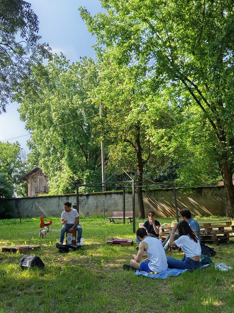 Persone sedute sul prato del parco in una giornata di apertura libera